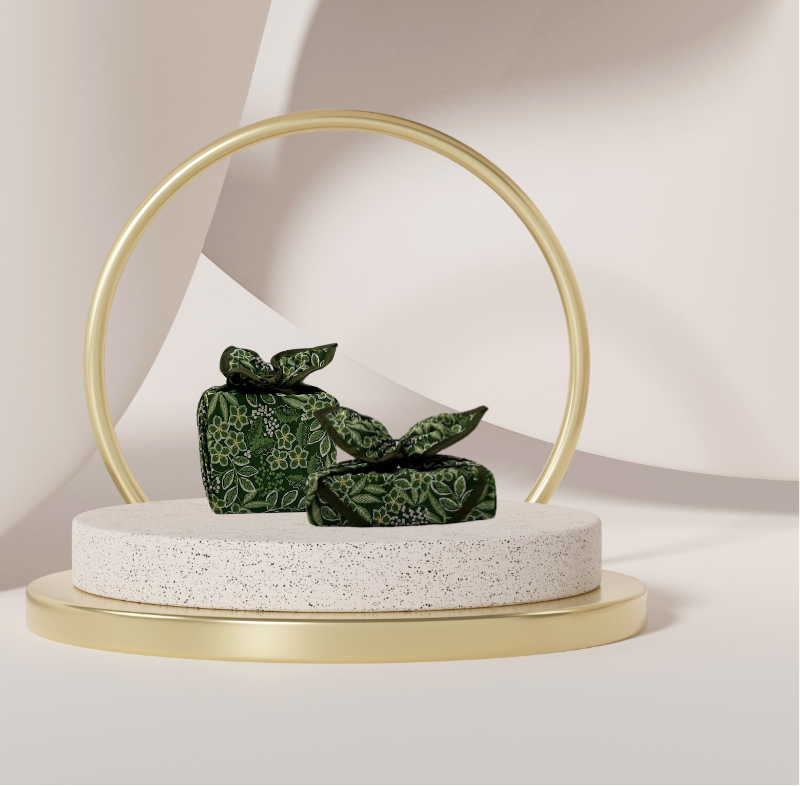 Fabric gift wrap with a winter garden theme, featuring floral patterns including evergreen leaves and berries. Luxury, eco-friendly, embroidery personalisation