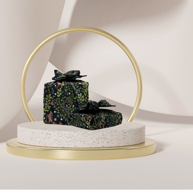 A fabric gift wrap with a festive winter design, featuring reindeer and snowflakes pattern. 
Luxury, eco-friendly, embroidery personalisation 