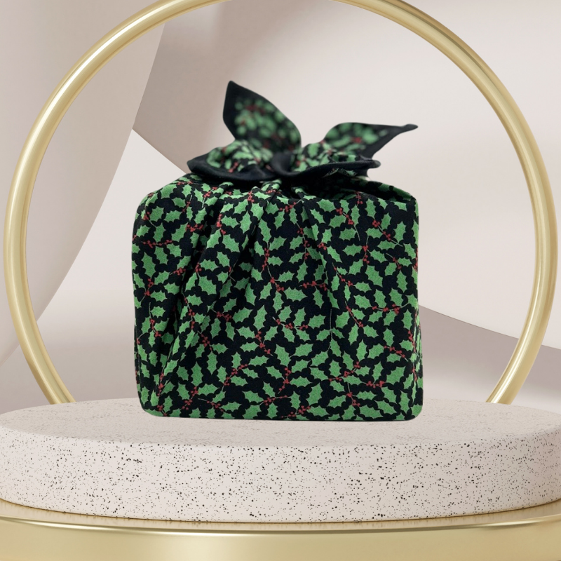 A fabric gift wrap with a Christmas holly pattern, luxury, personalised embroidery, eco friendly 