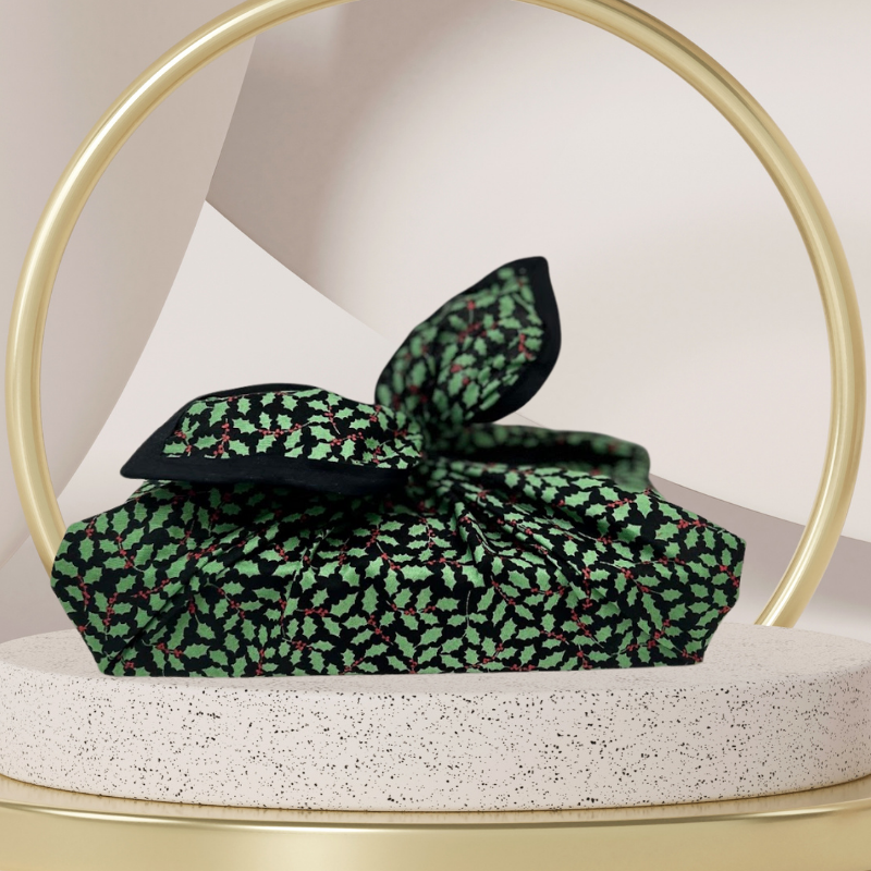 A fabric gift wrap with a Christmas holly pattern, luxury, personalised embroidery, eco friendly 