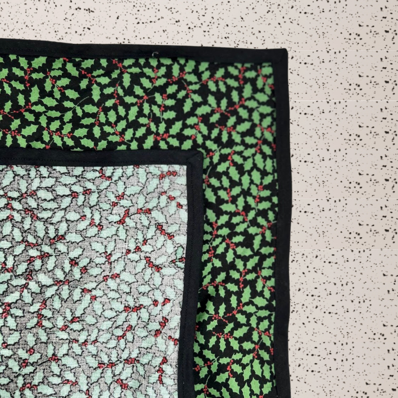 A fabric gift wrap with a Christmas holly pattern, luxury, personalised embroidery, eco friendly 