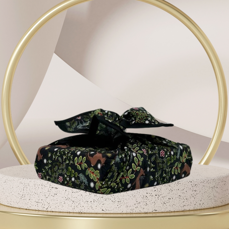 A fabric gift wrap with a festive winter design, featuring reindeer and snowflakes pattern. 
Luxury, eco-friendly, embroidery personalisation 