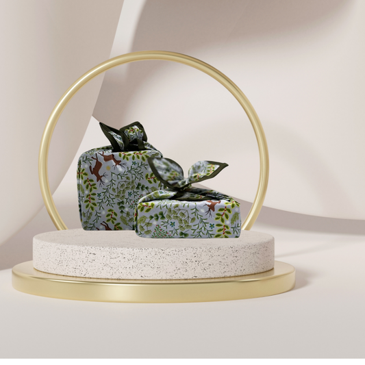 A reusable fabric gift wrap with a Christmas-themed design featuring reindeer, snowflakes, evergreen trees, and floral detail.
Luxury, eco-friendly, embroidery personalisation 