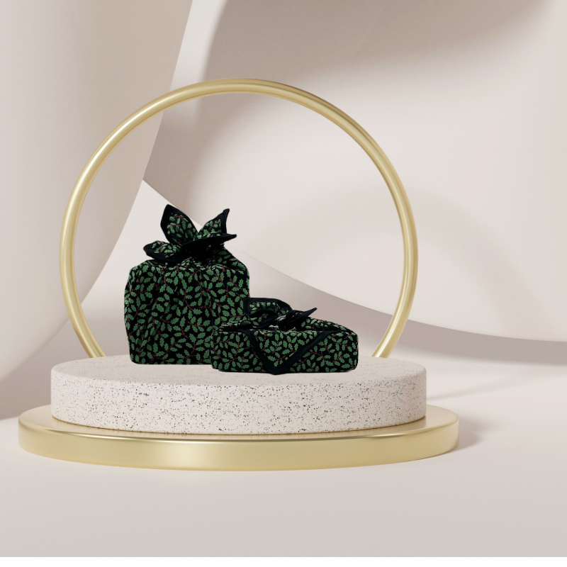 A reusable fabric gift wrap with a Christmas holly pattern, luxury, personalised embroidery, eco friendly 