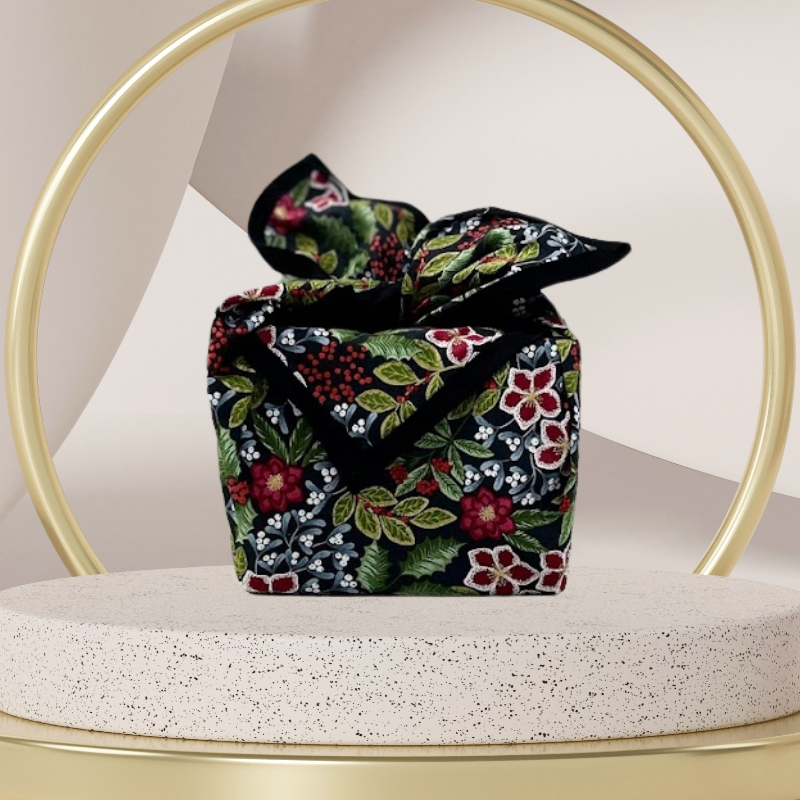 A fabric gift wrap with a floral pattern featuring crimson leaves, winter foliage, and blooming flowers. Luxury, eco-friendly, embroidery personalisation   