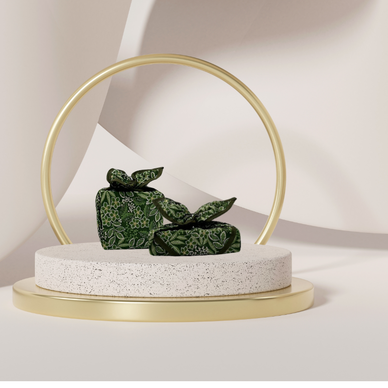Fabric gift wrap with a winter garden theme, featuring floral patterns including evergreen leaves and berries. Luxury, eco-friendly, embroidery personalisation 