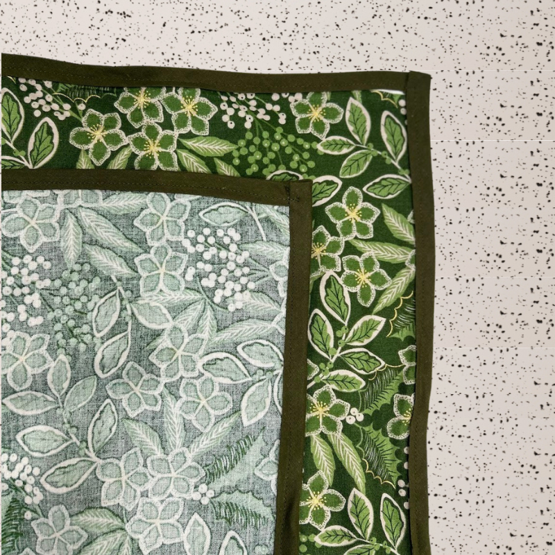 Fabric gift wrap with a winter garden theme, featuring floral patterns including evergreen leaves and berries. Luxury, eco-friendly, embroidery personalisation 