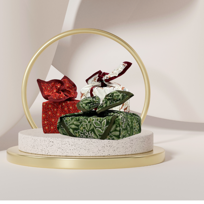 Fabric gift wrap with a winter garden theme, featuring floral patterns including evergreen leaves and berries. Luxury, eco-friendly, embroidery personalisation 