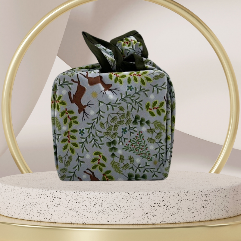 A reusable fabric gift wrap with a Christmas-themed design featuring reindeer, snowflakes, evergreen trees, and floral detail.
Luxury, eco-friendly, embroidery personalisation 