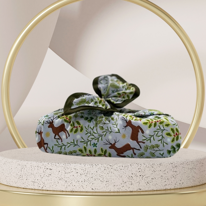 A reusable fabric gift wrap with a Christmas-themed design featuring reindeer, snowflakes, evergreen trees, and floral detail.
Luxury, eco-friendly, embroidery personalisation 