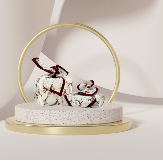 A reusable fabric gift wrap with a reindeer and snow design. Luxury, eco-friendly, embroidery personalisation 